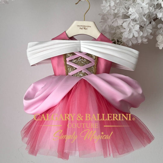 Order princess dresses for baby girl Pink and white dress on a hanger with 'Calgary & Ballerini Couture' branding.