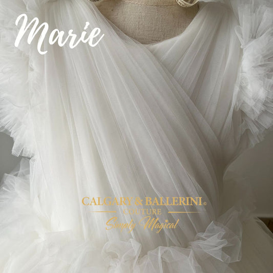 Elegant white flower girl dress with flowing skirt and rhinestones