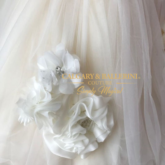 close up of handmade flower on flower girl gown