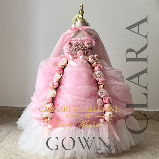 Step into the magical world of Clara from 'The Nutcracker' with our custom girls' costume. Discover a floor-length ballgown adorned with pink roses, a luxurious cape, and exquisite lace details. Elevate your princess's elegance and shop now at Calgary and Ballerini 