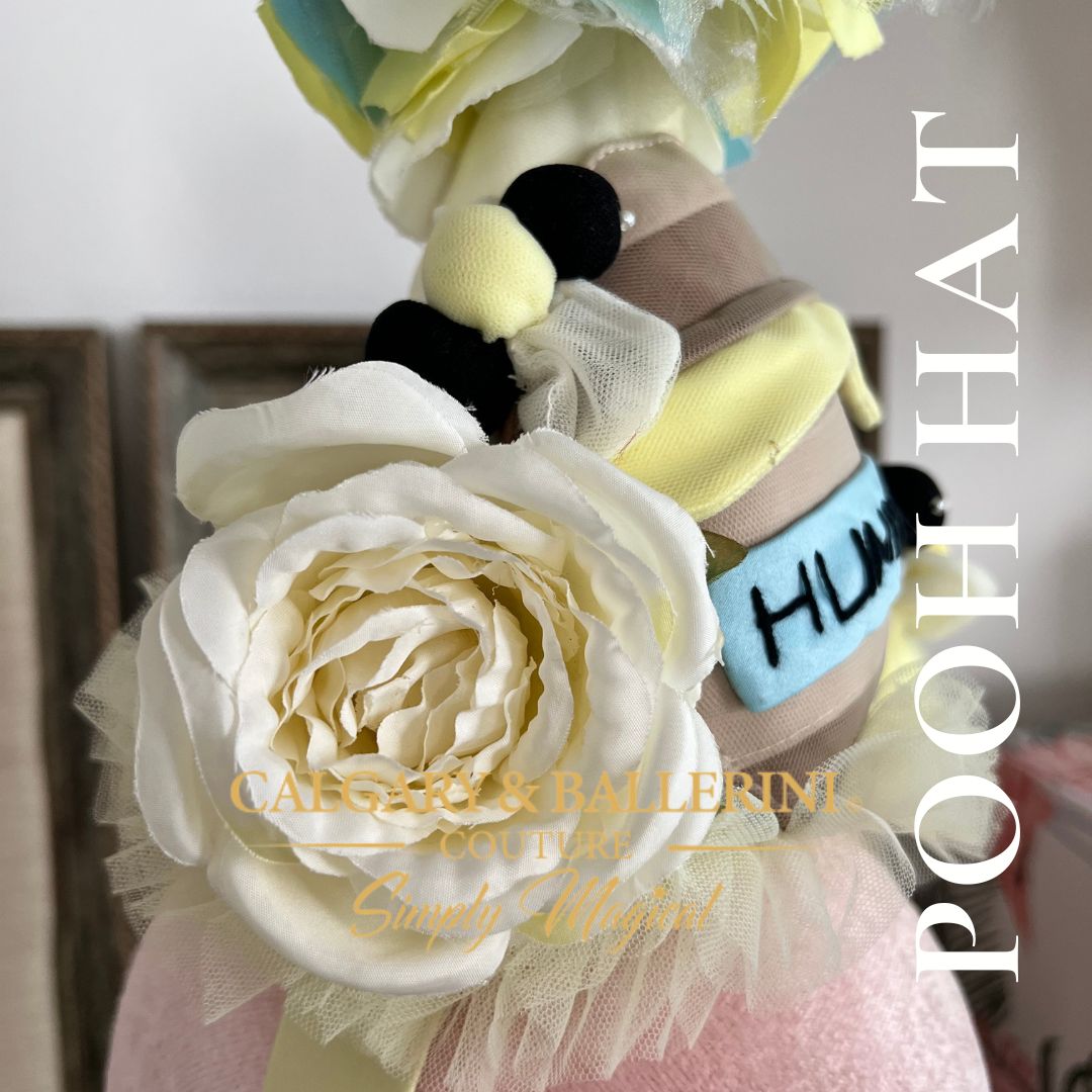 side view of hat with large ivory rose and bee