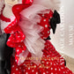 Designer birthday party Minnie polka dot gown with handmade lace detailing and tiered tulle ruffles, luxury red and white princess style dress for toddlers, Calgary and Ballerini artisan couture.