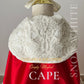 Child’s red princess cape with elegant white details