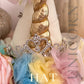 Custom unicorn party hat with delicate flowers, glittery embellishments, and a whimsical design for birthdays and events