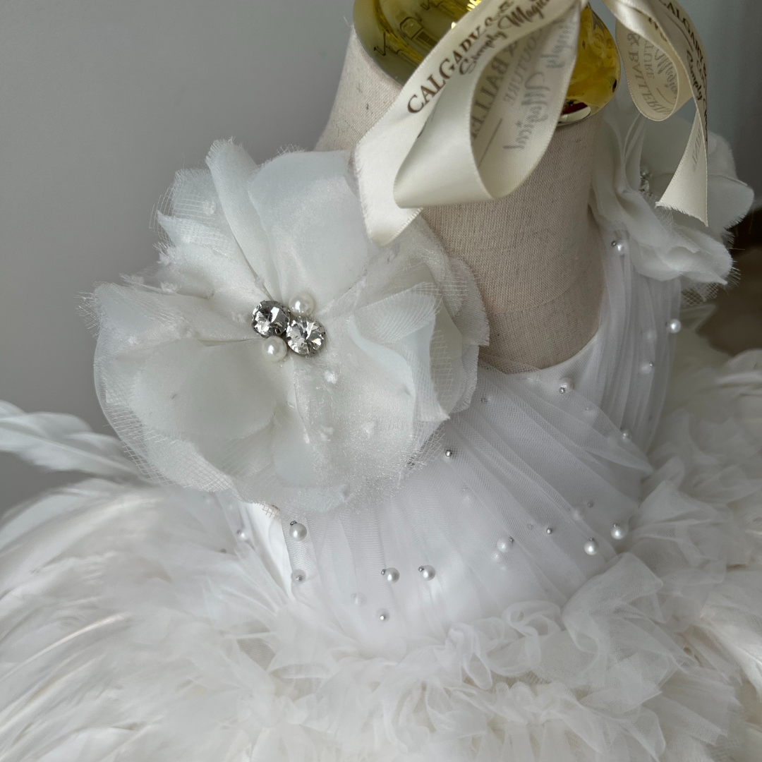 Stunning flower girl dress made with white feathers and satin bodice, perfect for weddings and milestone celebrations.