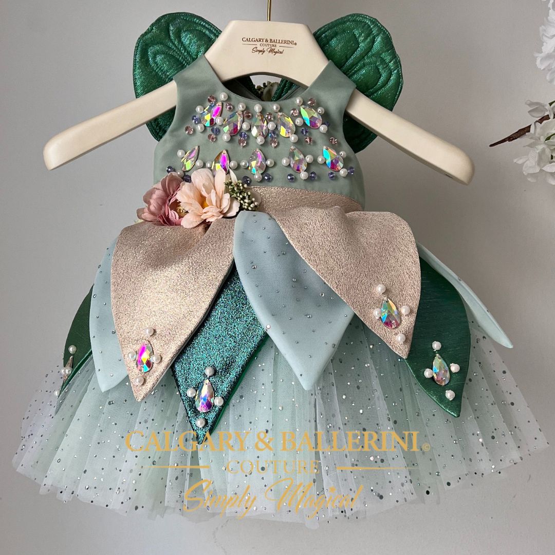 Handmade green fairy costume for babies featuring golden petals and whimsical fairy wings