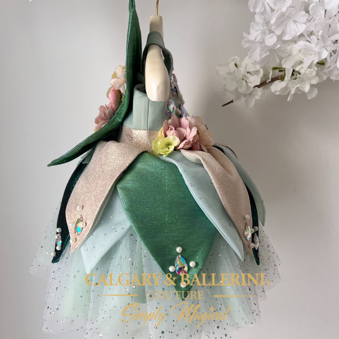 Infant fairy outfit with green petal skirt, gold accents, and lightweight wings for babies’ special moments