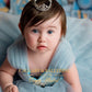Buy disney princess dresses for girls Baby in a light blue dress with a tiara, sitting on a soft surface 