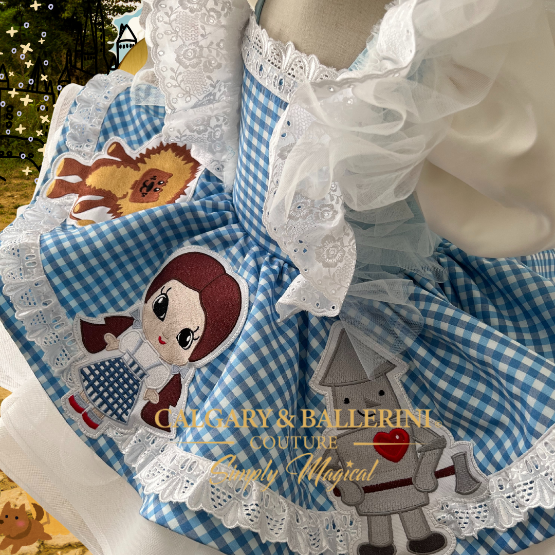 Shop this luxury Wizard of Oz birthday party dress for toddler girls, high-end heirloom Dorothy dress with hand-stitched storybook characters.