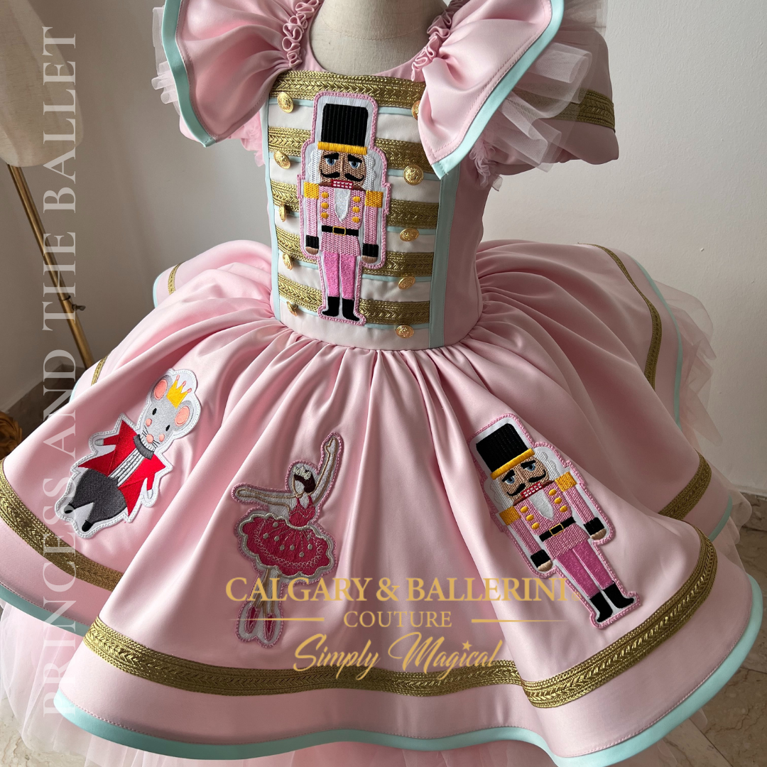 pink toddler girl dress with nutcracker figures 