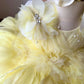 Order a bespoke yellow feather birthday dress and flower girl dress, featuring hand-stitched citrine feathers for a showstopping luxury look by Calgary and Ballerini