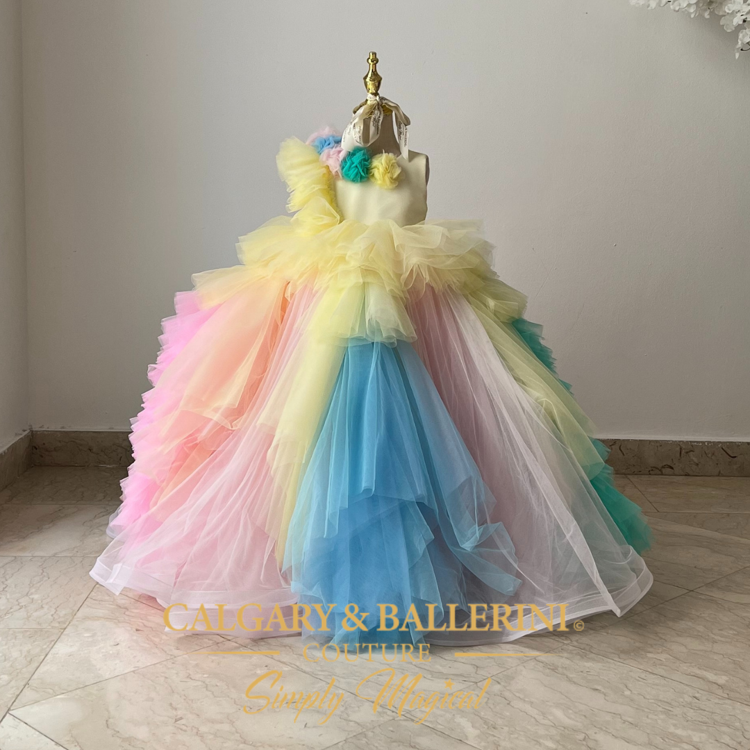 Pastel tulle Easter dress for girls in light pink, yellow, and blue with a matching cape.