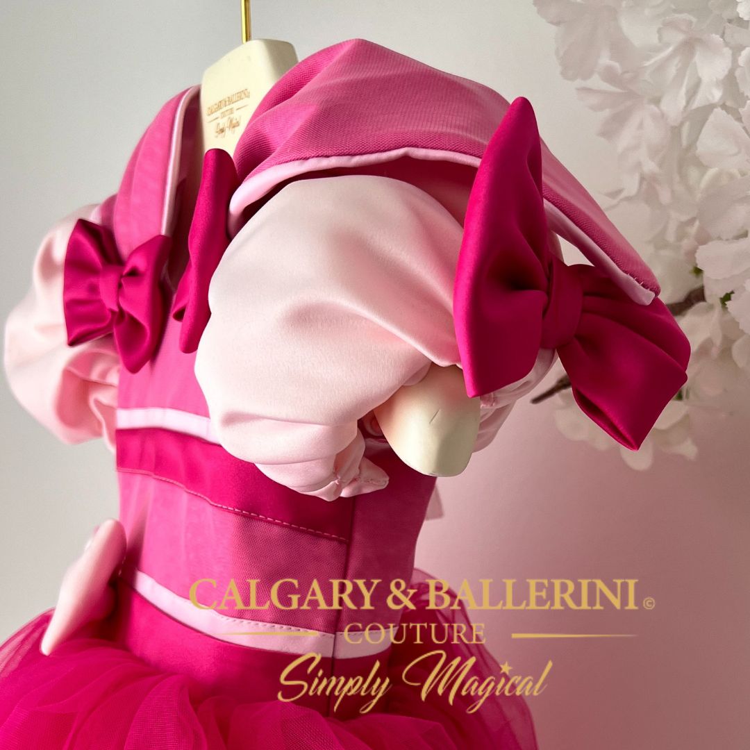 shop Disney inspired Pink dress with large bows on a mannequin, featuring 'Calgary & Ballerini' branding.