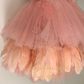Couture peach birthday dress with goose feather hem for toddlers and babies.