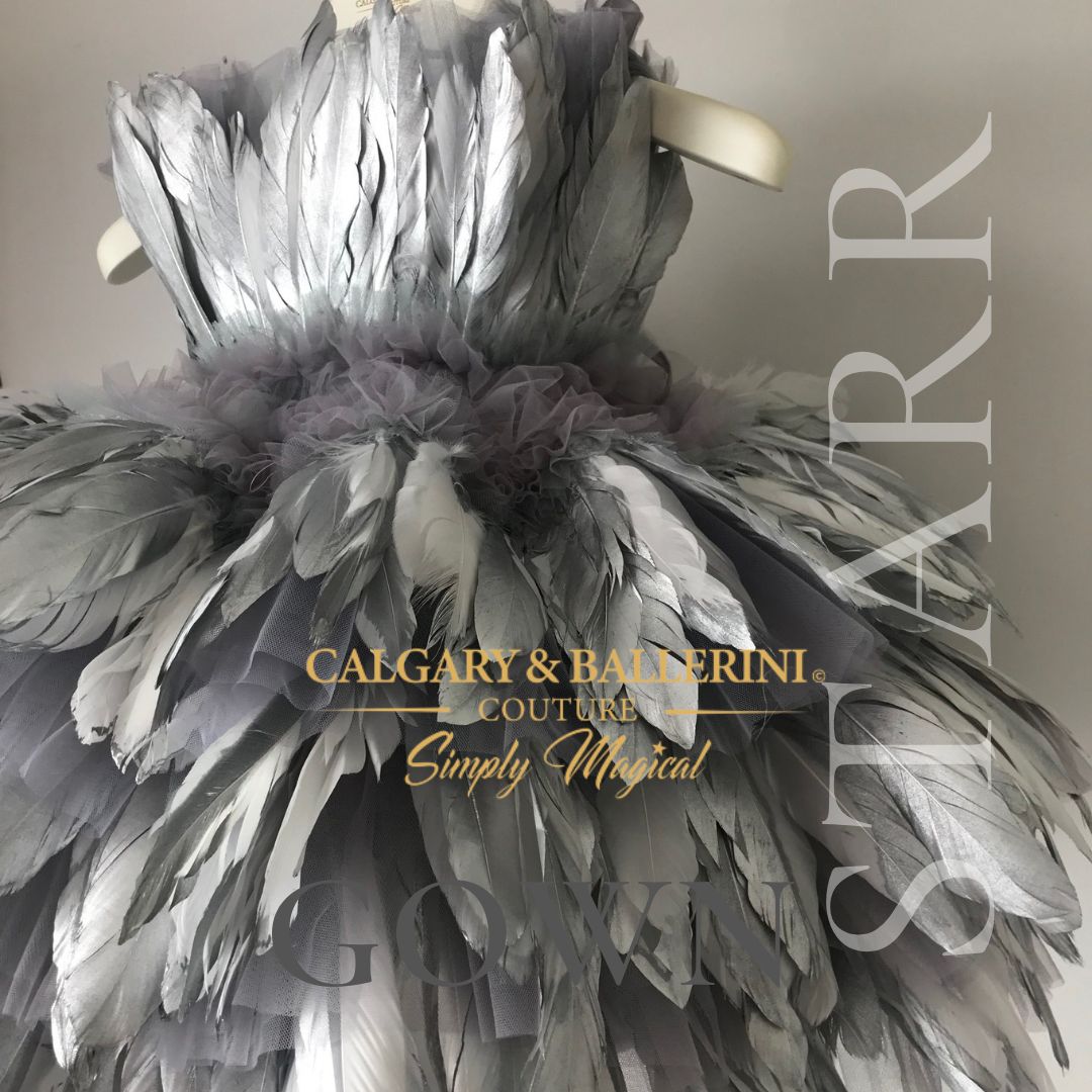 From the enchanting feathered bodice to the flowing skirt, every aspect of this dress is a masterpiece. Turn heads and make a statement as you walk down the aisle accompanied by your adorable flower girls wearing this ethereal feather dress. Elevate your wedding to new heights of luxury and create unforgettable memories with our Starr Silver Feather Dress.