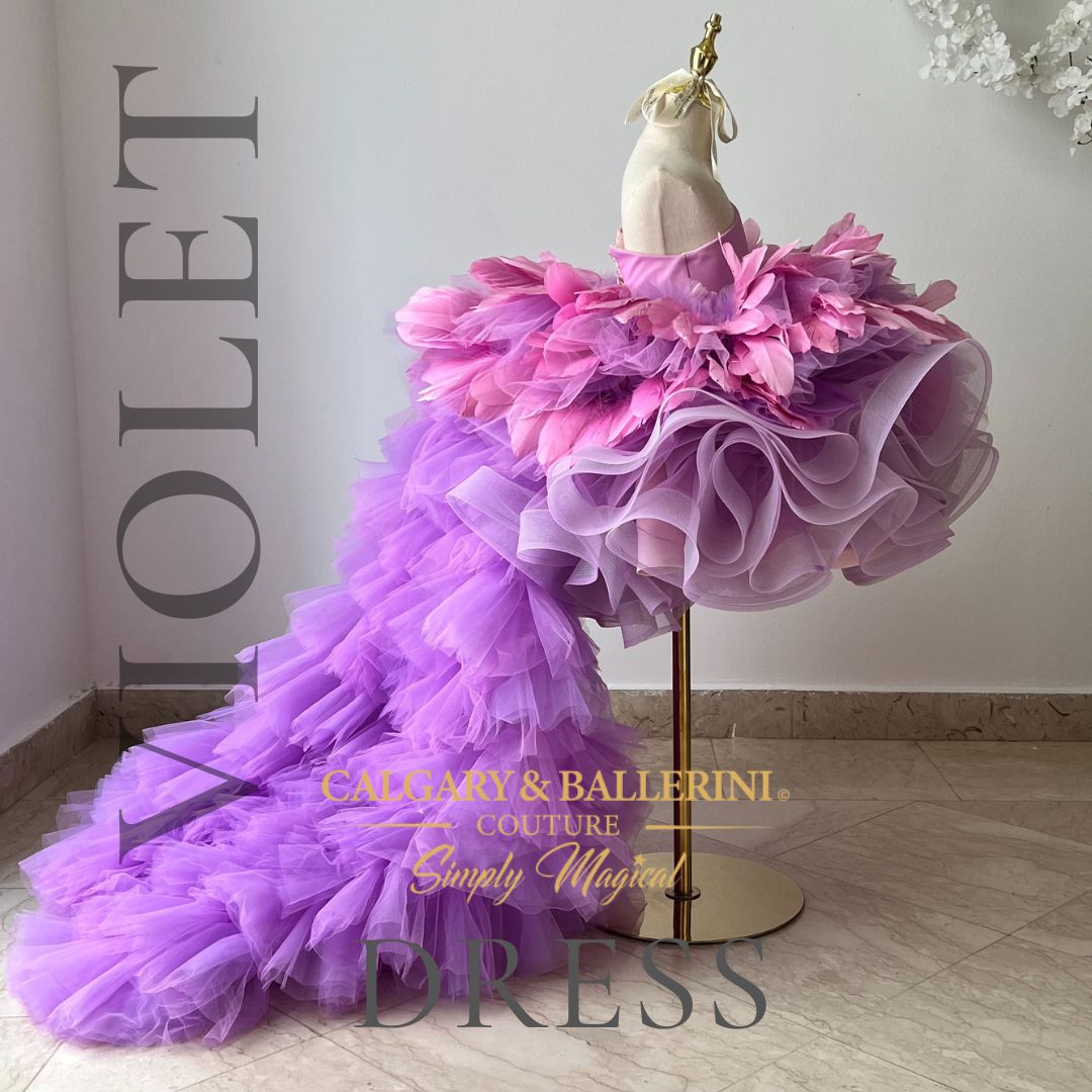 Adorable flower girl wearing a violet feather dress with a charming train, adding a touch of elegance and playfulness to any special occasion