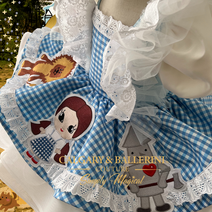 where to order Handmade heirloom Dorothy Wizard of Oz coquette birthday dresses online. Shop this luxury Wizard of Oz birthday party dress for toddler girls, high-end heirloom Dorothy dress with hand-stitched storybook characters.