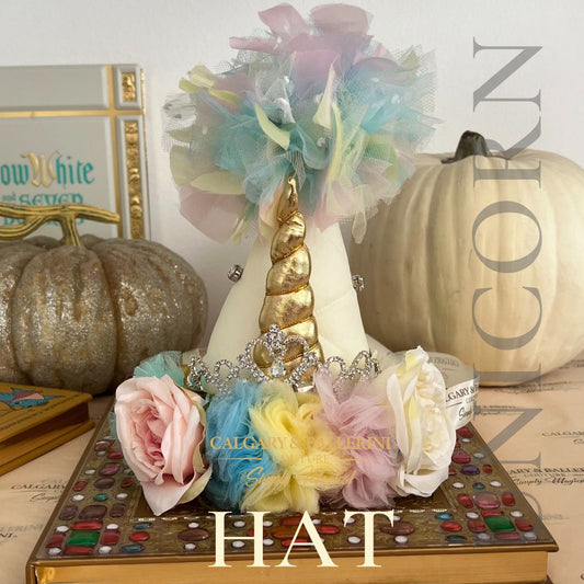 Whimsical unicorn party hat with handmade flowers, glittery accents, and a colorful horn for birthday celebrations.