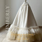 Elegant dresses for first communion with handcrafted lace details, a classic ball gown silhouette, and a matching cape