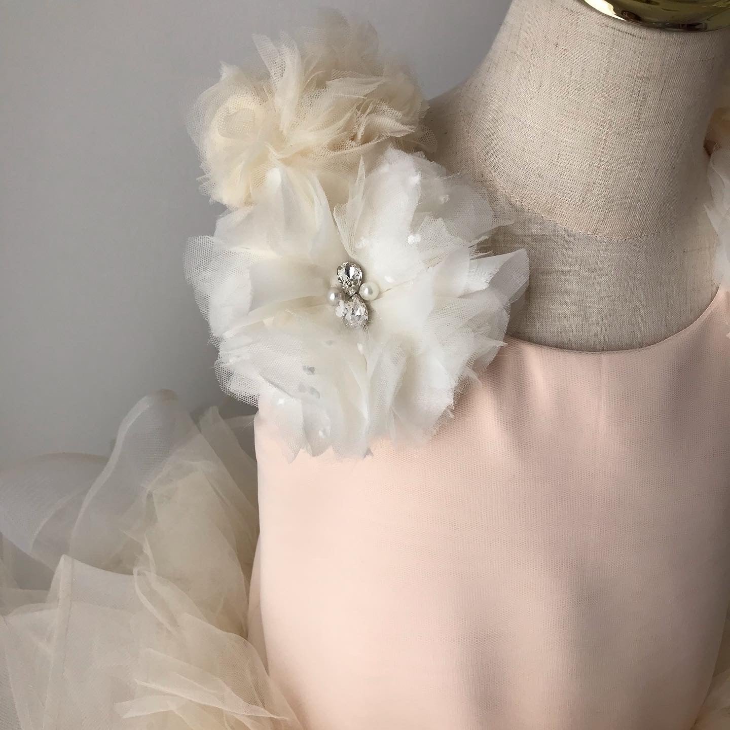 hand made tulle flowers on shoulder 