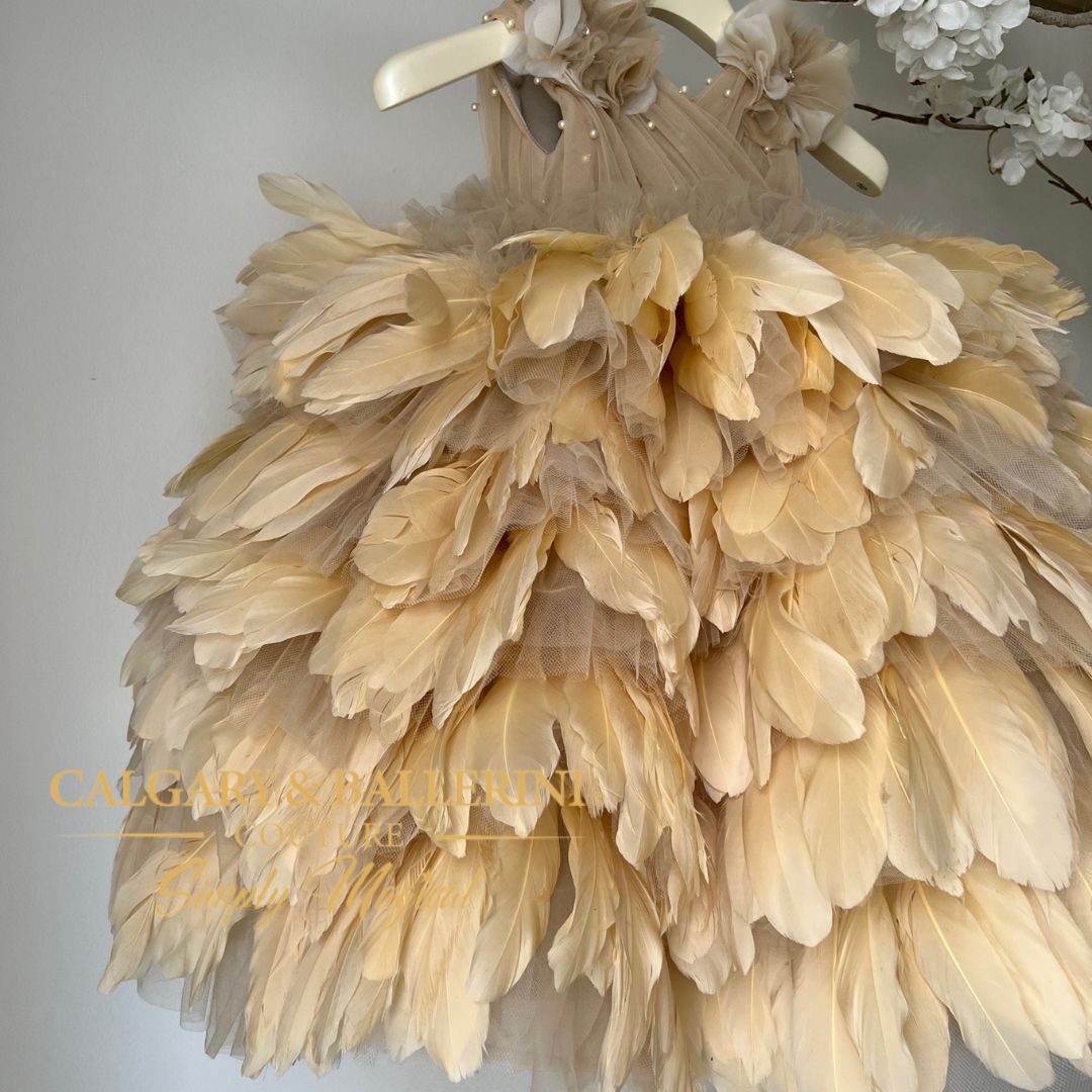 Nothing says luxury and style like a couture feather dress. This angel feather gown in golden fawn is a beautiful example of what can be achieved through expert craftsmanship