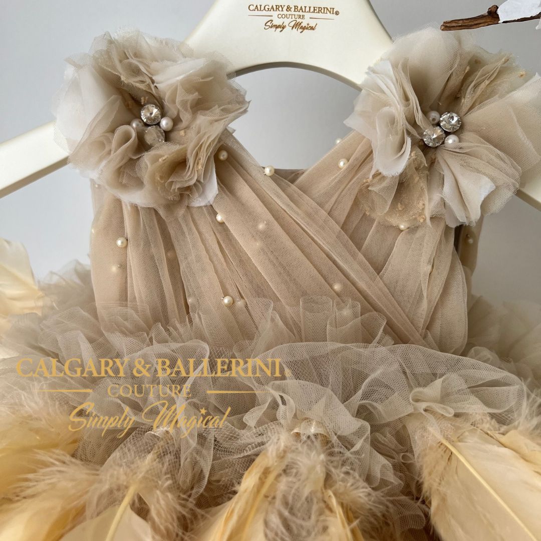 It's also ideal as a flower girl or birthday dress, with delicate details that never fail to dazzle onlookers. Tailored to perfection and offering unique style, this couture feather dress in gold