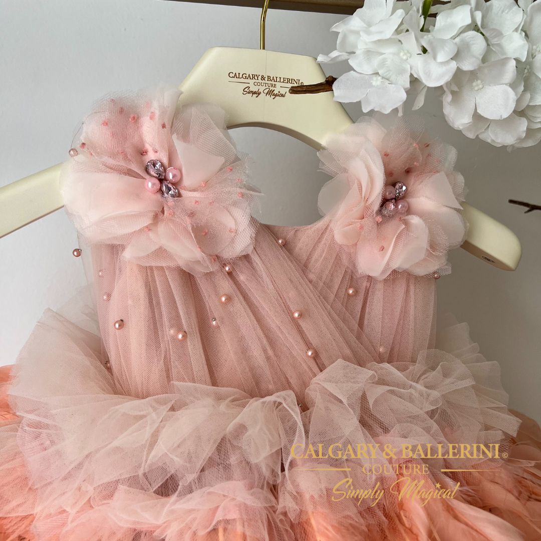 close up of pleated peach bodice and handmade flowers with rhinestone center