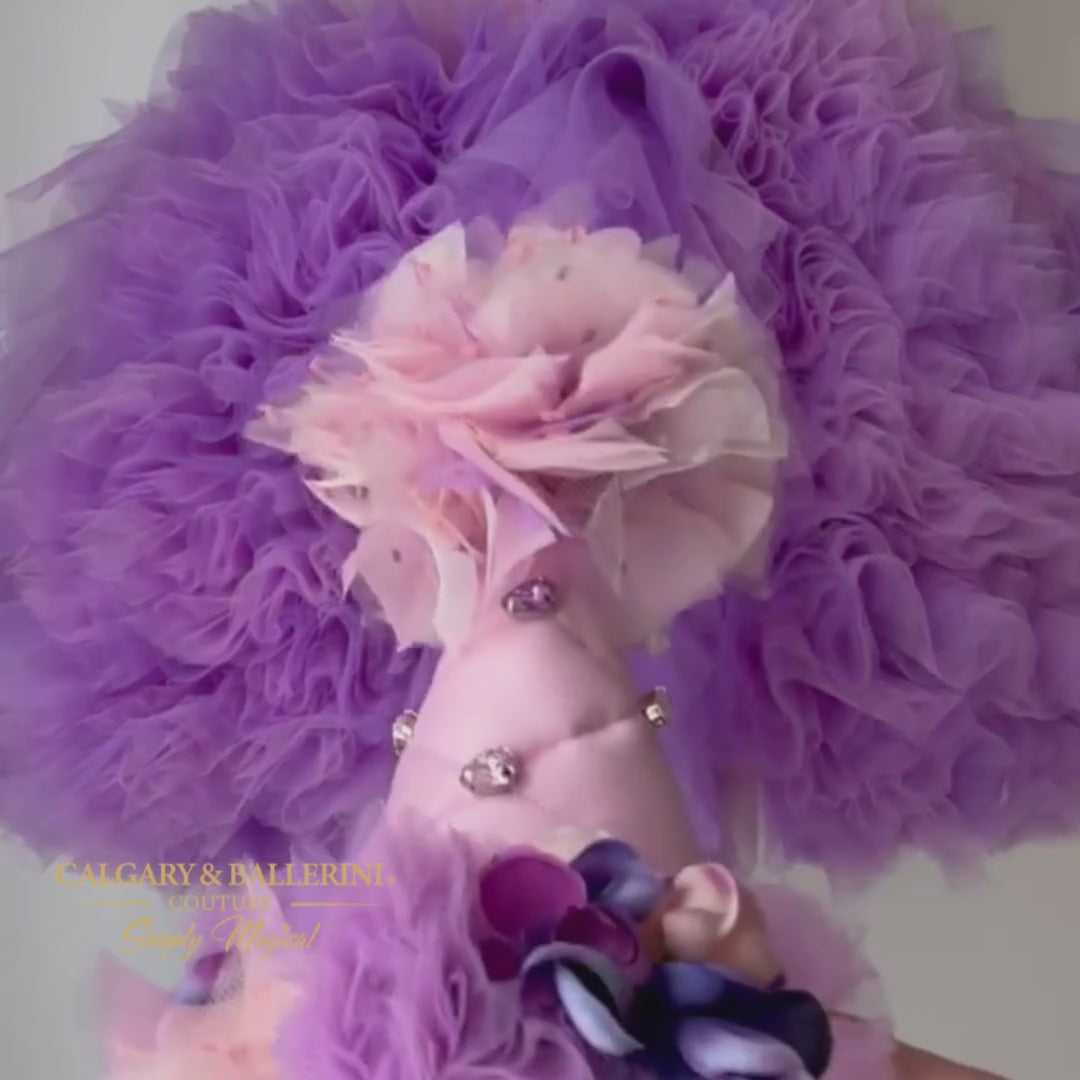 Celebrate your loved one's first birthday with this unique and festive birthday party hat in color violet mink. Custom-made with quilted satin, a tulle ruffle, and handmade flowers, this hat is perfect for any age.