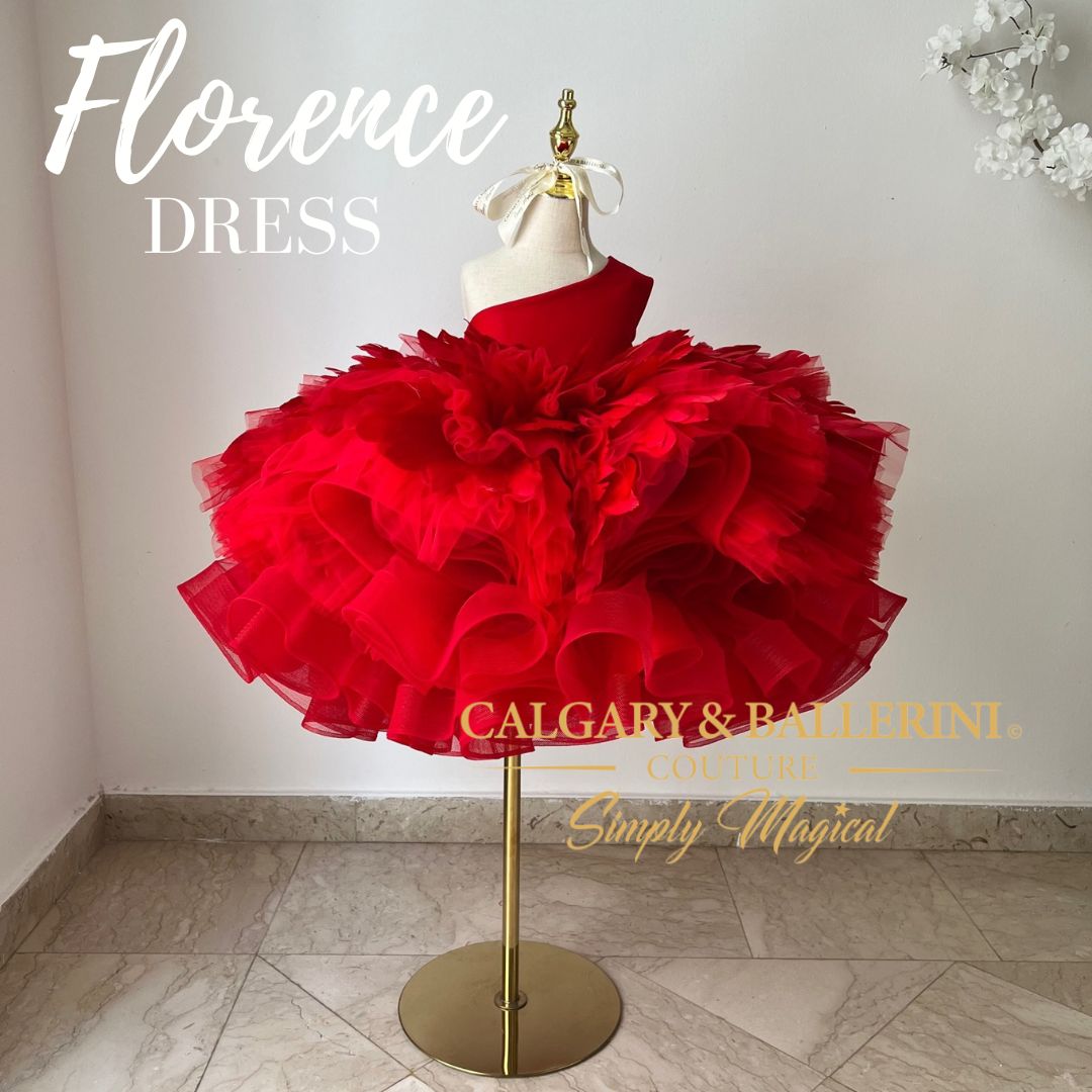 This red feather dress is the perfect mix of glamorous and fun for any young girl's special day. It features an off-the-shoulder satin bodice with a knee length tutu inspired by ballerinas; complete with goose feathers and horsehair braid that will leave your daughter feeling like an absolute princess.
