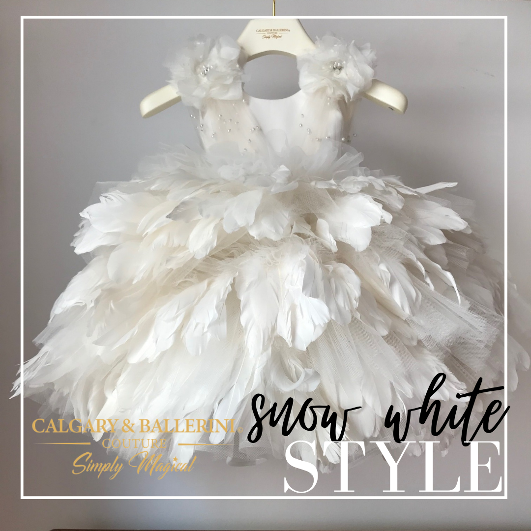 Girls’ long white feather dress with a dramatic floor-length design, ideal for special occasions and formal events.