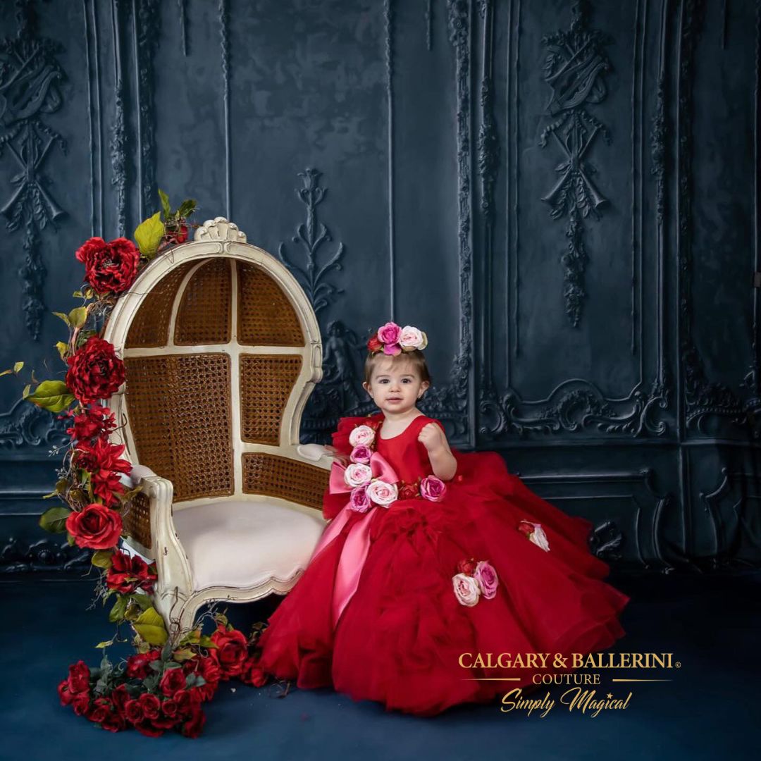 toddler posing in the red valentines dress