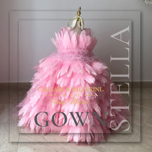 Step into a world of enchantment with our exquisite feather dress collection. This captivating photo showcases our stunning floor-length Stella gown in a luxurious petal pink color. Crafted with meticulous attention to detail, this couture children's dress features delicate goose feathers 