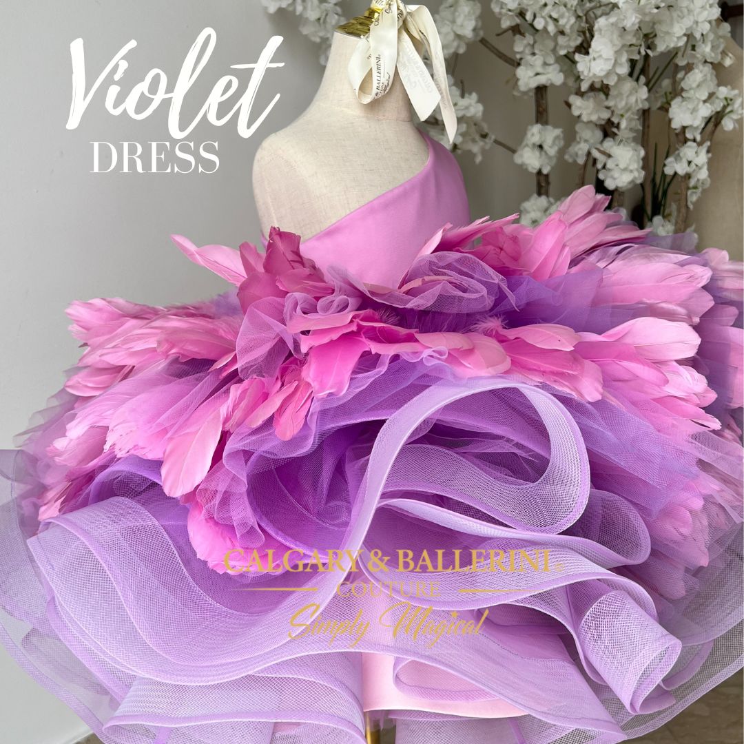 Elegance in motion: Flower girl wearing a feathered violet dress with a train, ideal for weddings