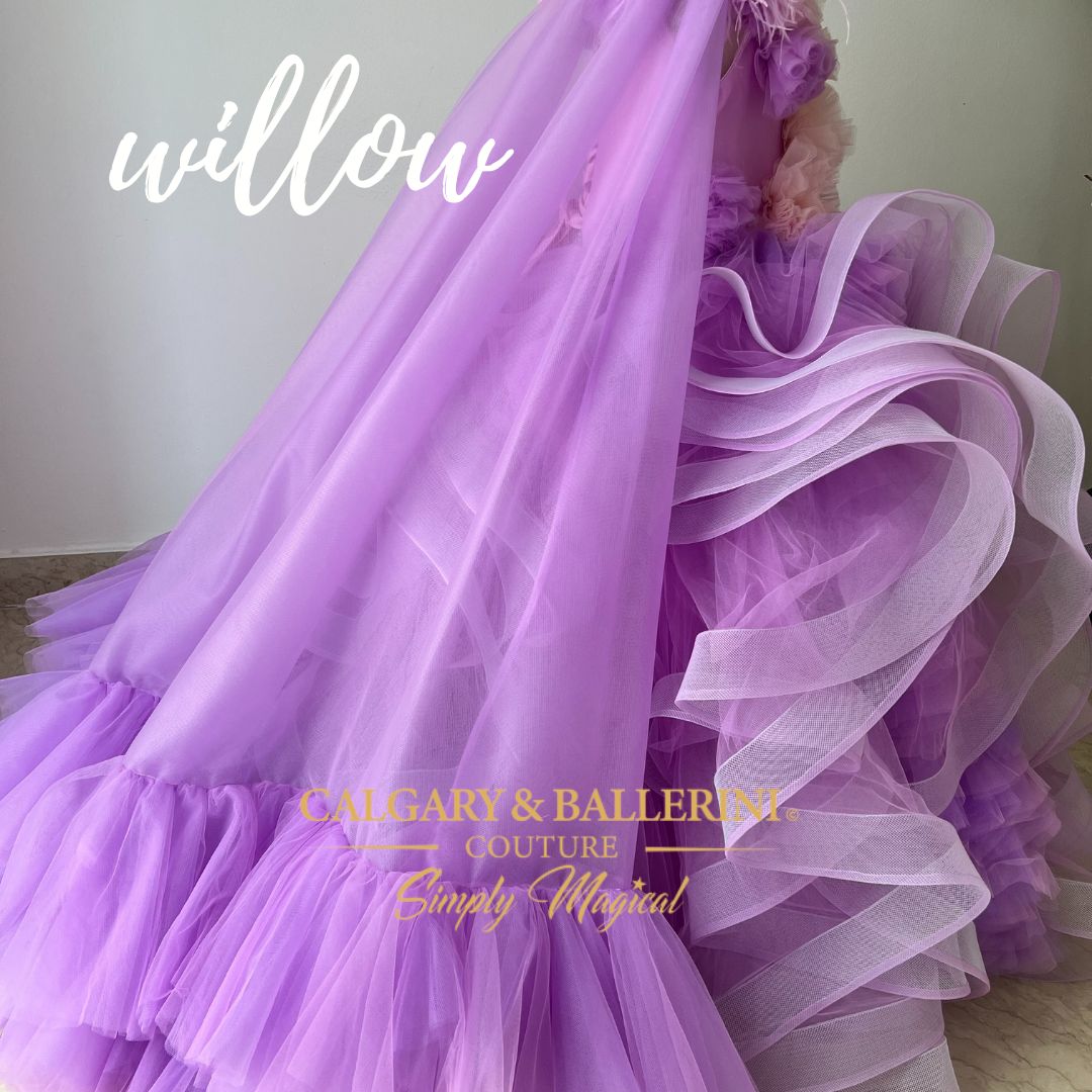  Set includes luxury dress, cape, head piece and matching purse. For the flower girl in your life, Willow from Violet Mink is the perfect dress. Featuring signature layers of over one hundred yards of horsehair tulle ruffles, this full floor length gown will give tons of volume and a beautiful 'fluff' effect. Furthermore, its bodice includes handmade flower appliques and side sleeve feather details